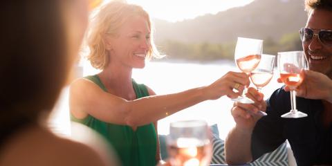 Friends toasting with wine on board their yacht