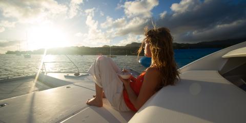 Girl eating cereal on boat at sunrise
