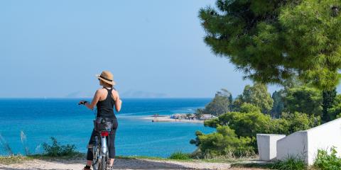 Woman cycling on Corfu Island, Greece